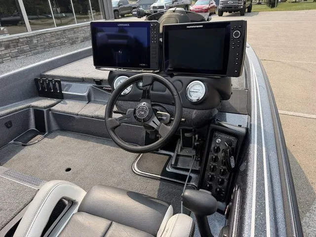 Slide: The Image of The image shows the cockpit of a 2022 Phoenix 721 ProXP boat with two large screens. - 7