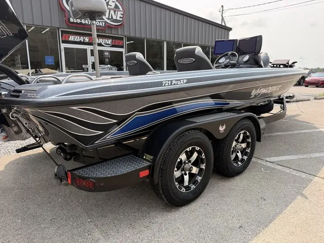 Slide: The Image of A gray 2022 Phoenix 721 ProXP boat on a trailer in front of a building. - 4