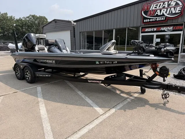 Slide: The Image of A 2022 Phoenix 721 ProXP bass boat on a trailer in front of a building. - 10