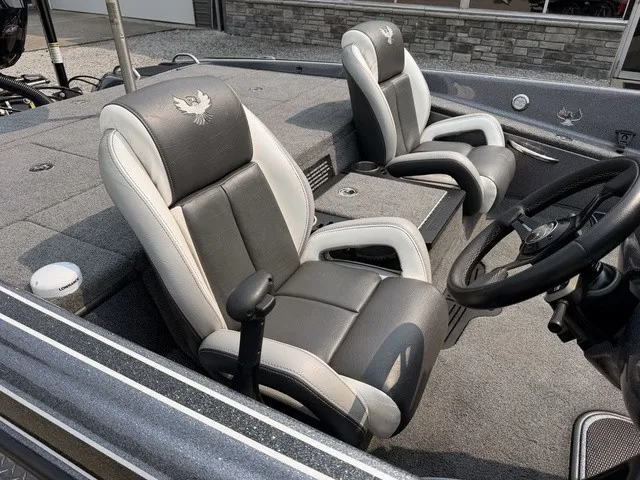 Slide: The Image of Interior view of a 2022 Phoenix 721 ProXP boat with two cushioned seats and a steering wheel. - 8