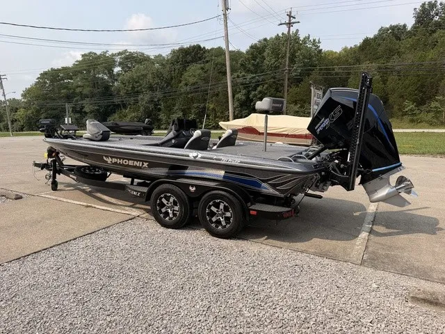 Slide: The Image of A gray 2022 Phoenix 721 ProXP boat on a trailer in a parking lot. - 17