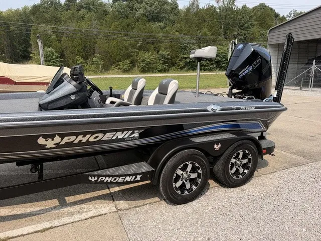 Slide: The Image of A black 2022 Phoenix 721 ProXP boat on a trailer in a yard. - 16