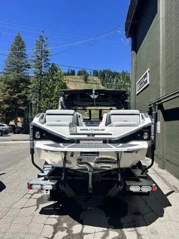 Slide: The Image of The image shows a 2022 Nautique Super Air Nautique G23 Paragon boat parked on a street. - 3