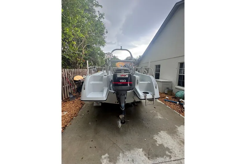 Slide: The Image of 1997 Citation Seapro 220 Aquadek boat with Yamaha 150 outboard motor in driveway. - 9