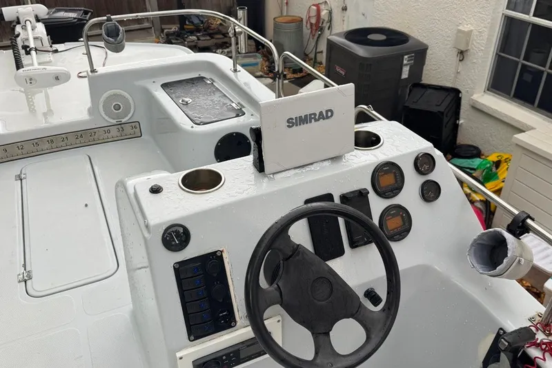 Slide: The Image of 1997 Citation Seapro 220 Aquadek boat dashboard with Simrad navigation system and gauges. - 15