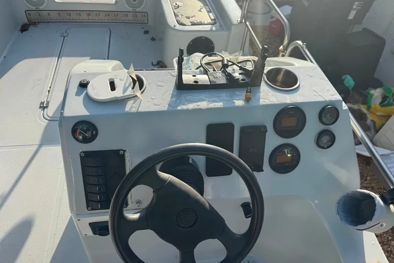 Slide: The Image of 1997 Citation Seapro 220 Aquadek boat dashboard with steering wheel and control panel. - 7