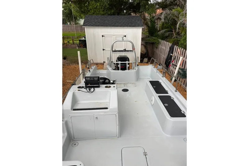 Slide: The Image of 1997 Citation Seapro 220 Aquadek boat with spacious deck and storage compartments. - 13