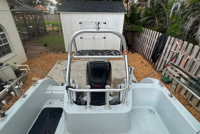 Slide: The Image of 1997 Citation Seapro 220 Aquadek boat with motor, parked in a backyard setting. - 19