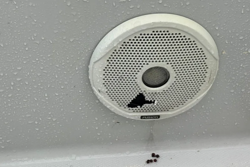Slide: The Image of Damaged Fusion speaker on Citation Seapro 220 Aquadek boat, 1997 model, with water droplets. - 18