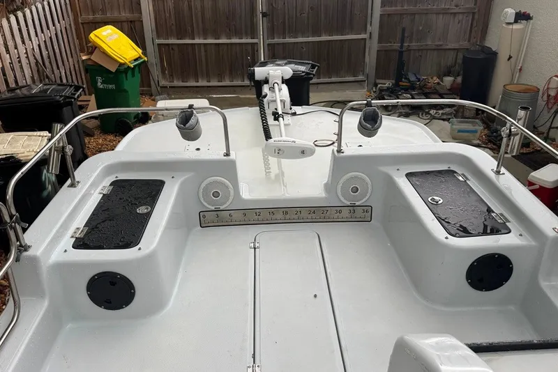 Slide: The Image of 1997 Citation Seapro 220 Aquadek boat deck with storage compartments and railing. - 14