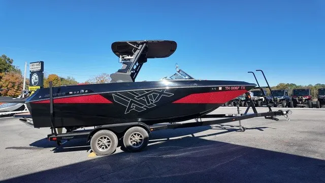 Slide: The Image of A black 2023 ATX Boat 22 S with red accents on a trailer. - 3