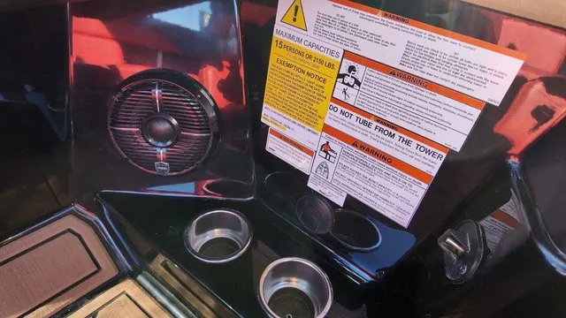 Slide: The Image of The image shows the interior of a 2023 ATX Boats 22 S with a speaker and warning labels. - 16