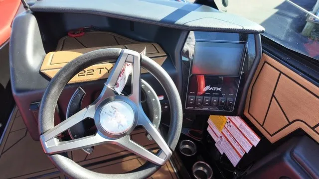 Slide: The Image of The image shows the cockpit of a 2023 ATX Boats 22 S with a modern steering wheel and digital display. - 17