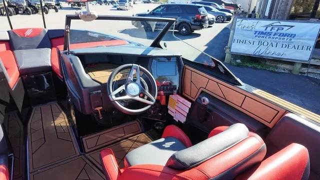 Slide: The Image of The image shows the cockpit of a 2023 ATX Boats 22 S with modern controls and red seating. - 13