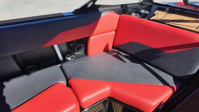 Slide: The Image of The image shows the seating area of a 2023 ATX Boats 22 S with red and gray upholstery. - 11