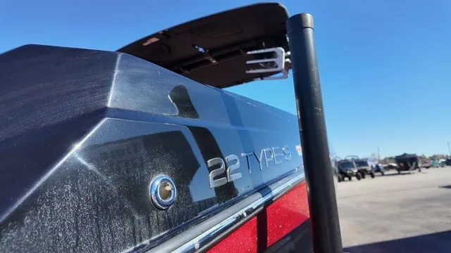 Slide: The Image of Close-up of a 2023 ATX Boats 22 S, featuring a sleek black and red hull. - 21