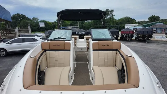 Slide: The Image of The image shows a 2015 Sea Ray SLX 250 boat with beige seats and a black canopy. - 13