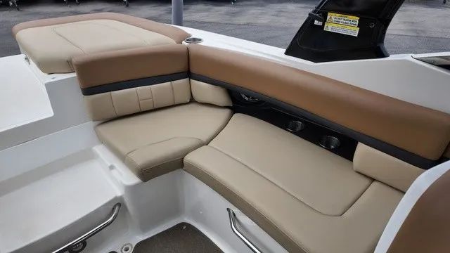 Slide: The Image of The 2015 Sea Ray SLX 250 features elegant beige and brown upholstery in the seating area. - 17