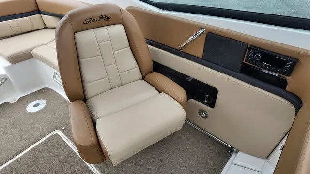 Slide: The Image of The interior of a 2015 Sea Ray SLX 250 features a beige and brown seat with armrests. - 18