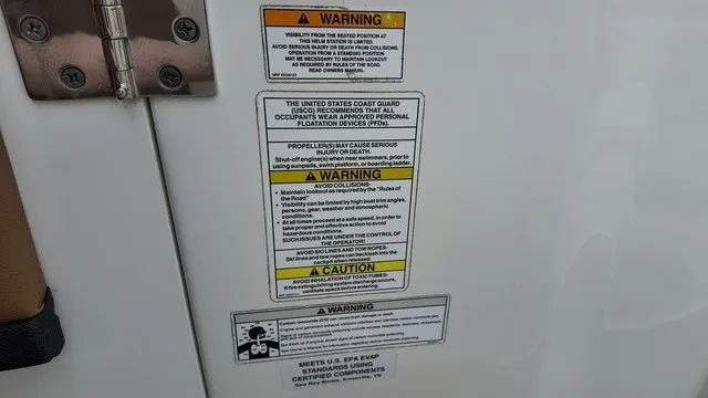 Slide: The Image of Warning labels and safety information on a boat, including U.S. Coast Guard recommendations. - 25