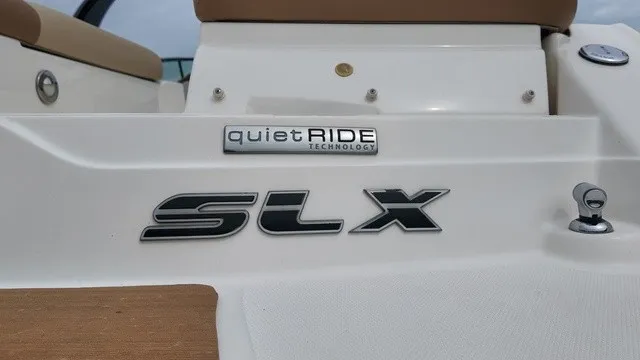 Slide: The Image of Close-up of the Sea Ray SLX 250 with "quietRIDE Technology" badge. - 33