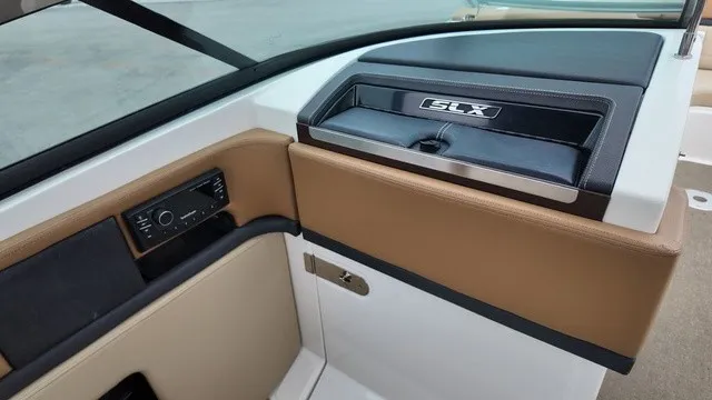 Slide: The Image of The image shows the cockpit of a 2015 Sea Ray SLX 250 with brown and black accents. - 19
