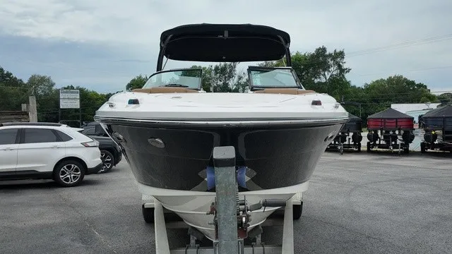 Slide: The Image of A 2015 Sea Ray SLX 250 boat on a trailer in a parking lot. - 8