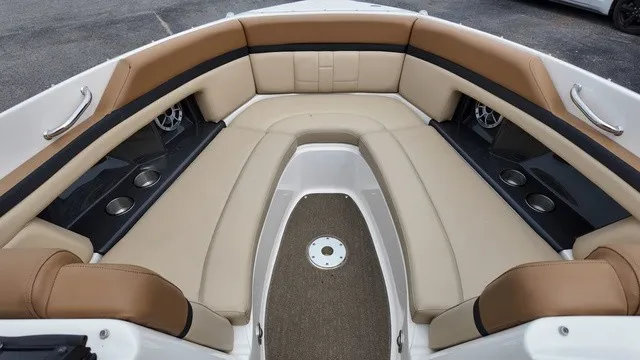 Slide: The Image of The image shows the bow area of a 2015 Sea Ray SLX 250 boat with beige upholstery. - 26