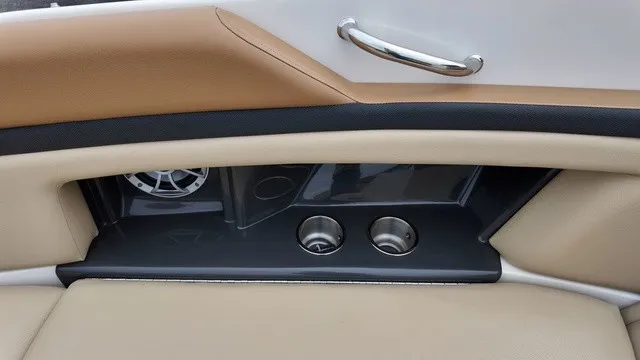 Slide: The Image of The image shows part of the interior of a Sea Ray SLX 250 boat with cup holders. - 28