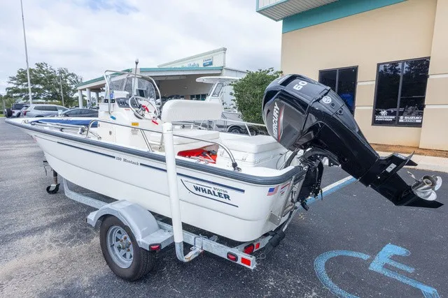 Slide: The Image of A 2012 Boston Whaler 150 Montawk on a trailer. The outboard motor is visible. - 6