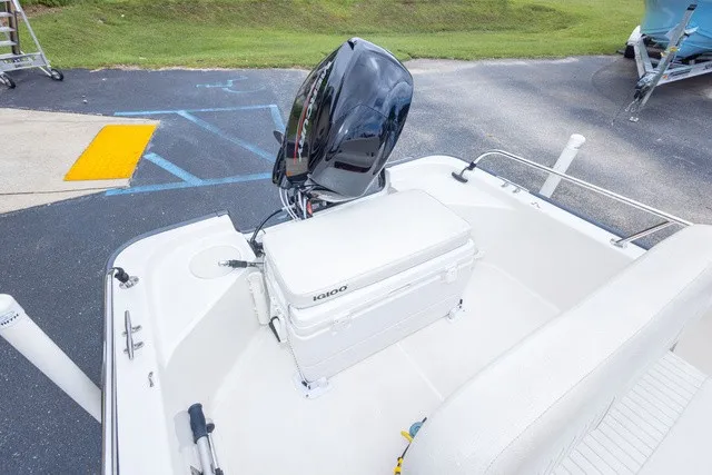 Slide: The Image of The image shows the stern of a 2012 Boston Whaler 150 Montawk with an outboard motor and a white cooler. - 18