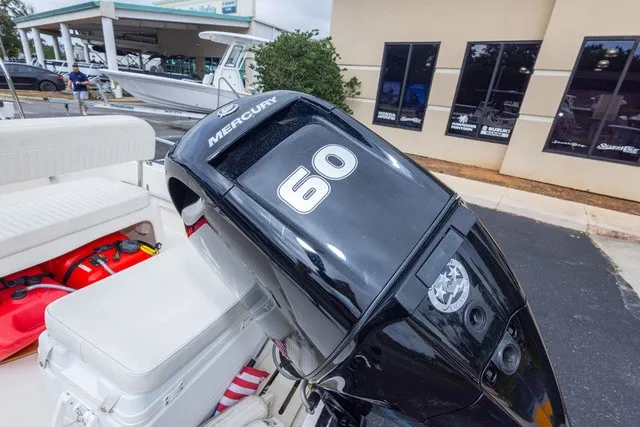 Slide: The Image of A Mercury 60 outboard motor is mounted on a Boston Whaler 150 Montawk boat. - 22
