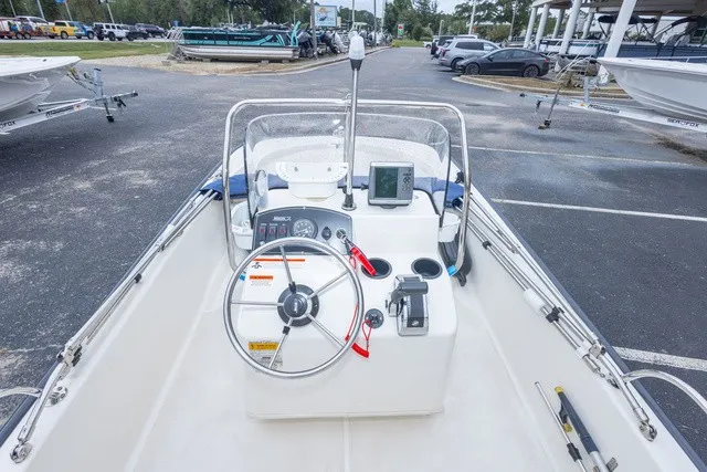 Slide: The Image of The image shows the cockpit of a 2012 Boston Whaler 150 Montawk with steering and instruments. - 16