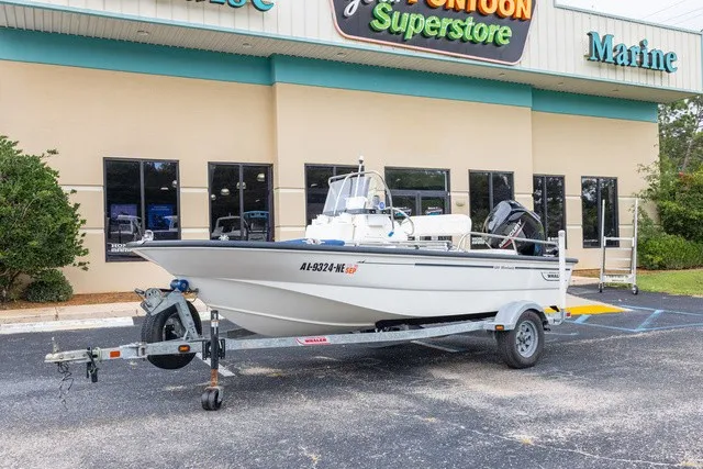 Slide: The Image of A 2012 Boston Whaler 150 Montawk on a trailer in front of a building. - 23