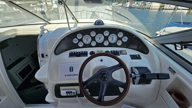 Slide: The Image of The image shows the cockpit of a 2001 Mustang 3200 Sport Cruiser with a wooden steering wheel and instruments. - 12