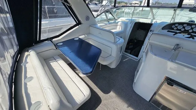 Slide: The Image of The image shows the cockpit of a 2001 Mustang 3200 Sport Cruiser with white seating and a blue table. - 7