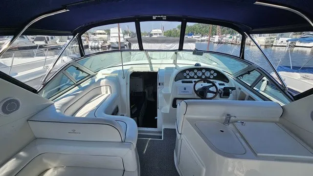 Slide: The Image of The image shows the cockpit of a 2001 Mustang 3200 Sport Cruiser with white seating and a steering wheel. - 13