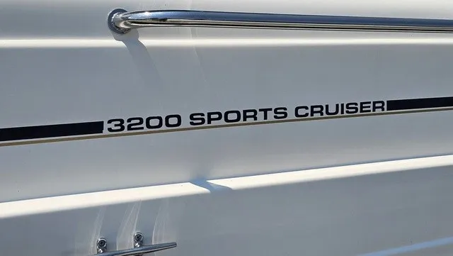 Slide: The Image of 2001 Mustang 3200 Sport Cruiser with a white hull and stainless steel railing. - 24