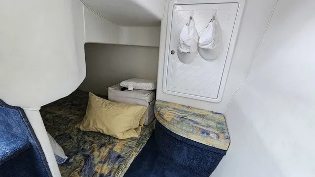 Slide: The Image of Interior of a 2001 Mustang 3200 Sport Cruiser with a cozy bed and storage space. - 20
