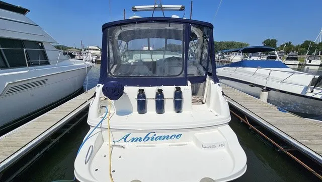 Slide: The Image of A 2001 Mustang 3200 Sport Cruiser docked. The name "Ambiance" is visible on the stern. - 5