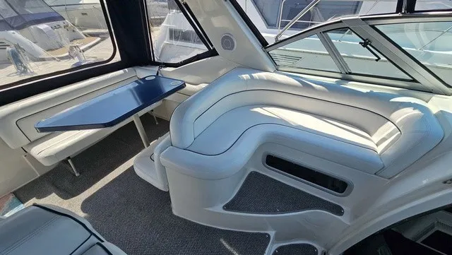 Slide: The Image of Interior of a 2001 Mustang 3200 Sport Cruiser with white upholstery and a blue table. - 9