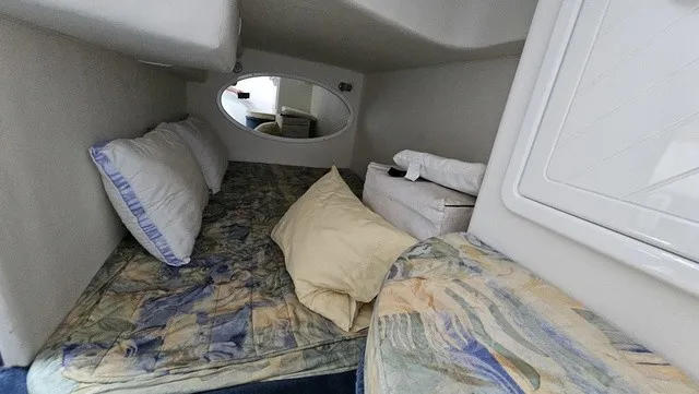 Slide: The Image of The image shows a cozy cabin with a bed, pillows, and an oval mirror. - 21