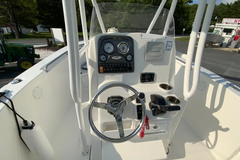 Slide: The Image of 2015 Tidewater 230 CC Adventure boat console with steering wheel and Garmin navigation system. - 12