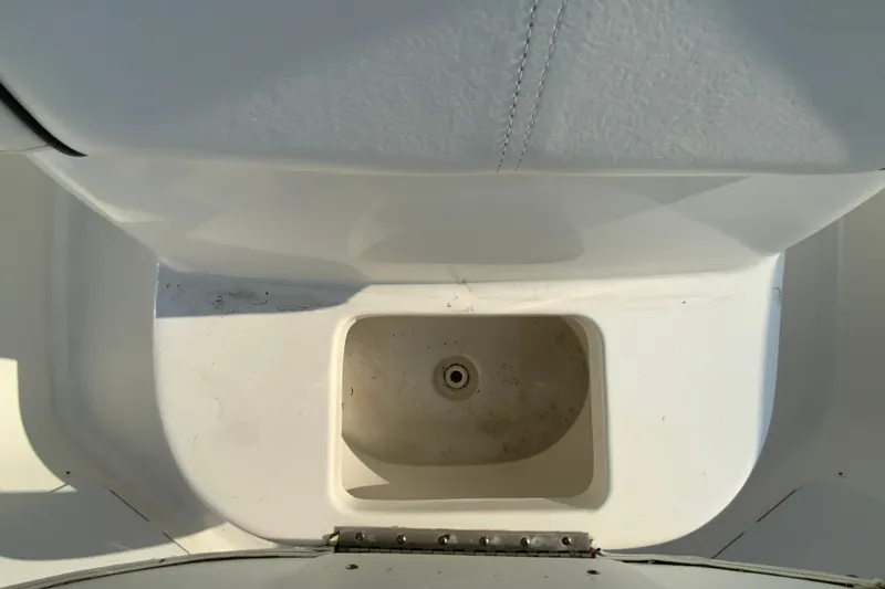 Slide: The Image of Storage compartment on a 2015 Tidewater 230 CC Adventure boat, featuring a clean, white interior. - 24