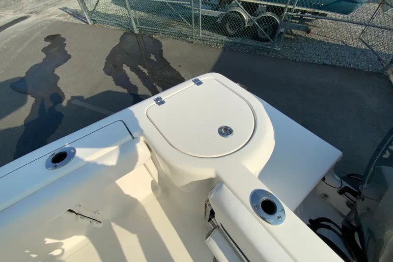 Slide: The Image of 2015 Tidewater 230 CC Adventure boat deck with storage compartment and rod holders. - 17