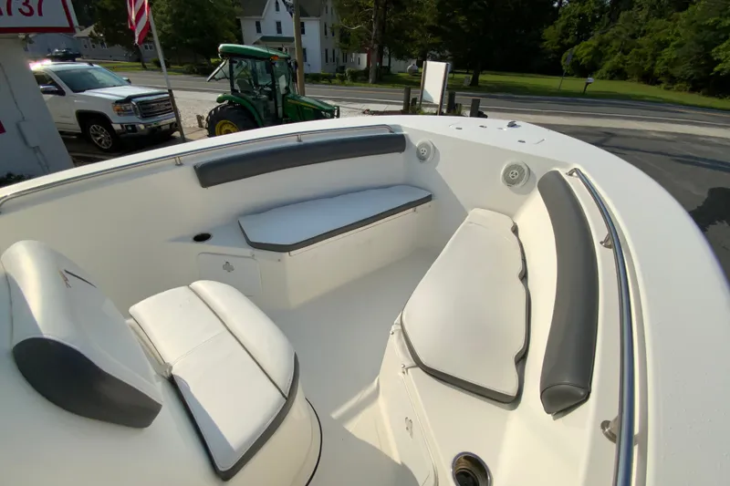 Slide: The Image of 2015 Tidewater 230 CC Adventure boat interior with cushioned seating and speakers. - 20