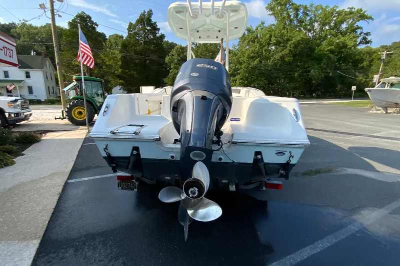 Slide: The Image of 2015 Tidewater 230 CC Adventure boat with outboard motor, parked outdoors. - 9