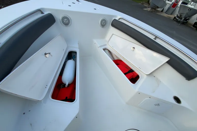 Slide: The Image of 2015 Tidewater 230 CC Adventure boat storage compartments with safety equipment. - 27