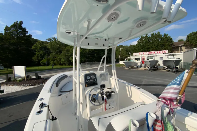 Slide: The Image of 2015 Tidewater 230 CC Adventure boat at dealership, featuring center console and T-top. - 11