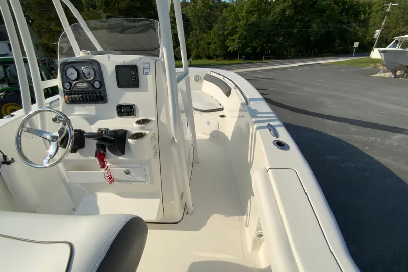 Slide: The Image of 2015 Tidewater 230 CC Adventure boat interior with steering console and seating. - 19